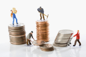 Figurines of manual workers with stacks of coins